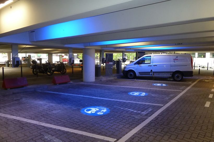 Mit blauem Logo gekennzeichnete Ladestationen für E-Fahrzeuge im Parkhaus P4.