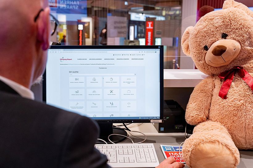 Neben dem Computer im Fundbüro am Hamburg Airport sitzt ein Teddy.