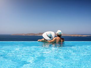 Reisendes Paar in einem Infinity-Pool genießen das Mittelmeer